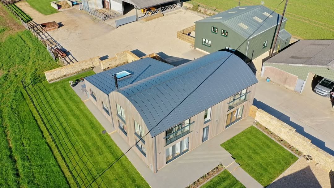 Barn conversion with standing seam barrelled roof using GreenCoat PLX Mountain Grey